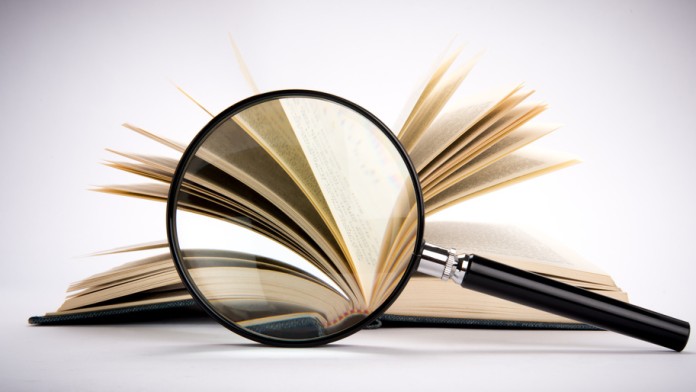 A magnifying glass in front of a book